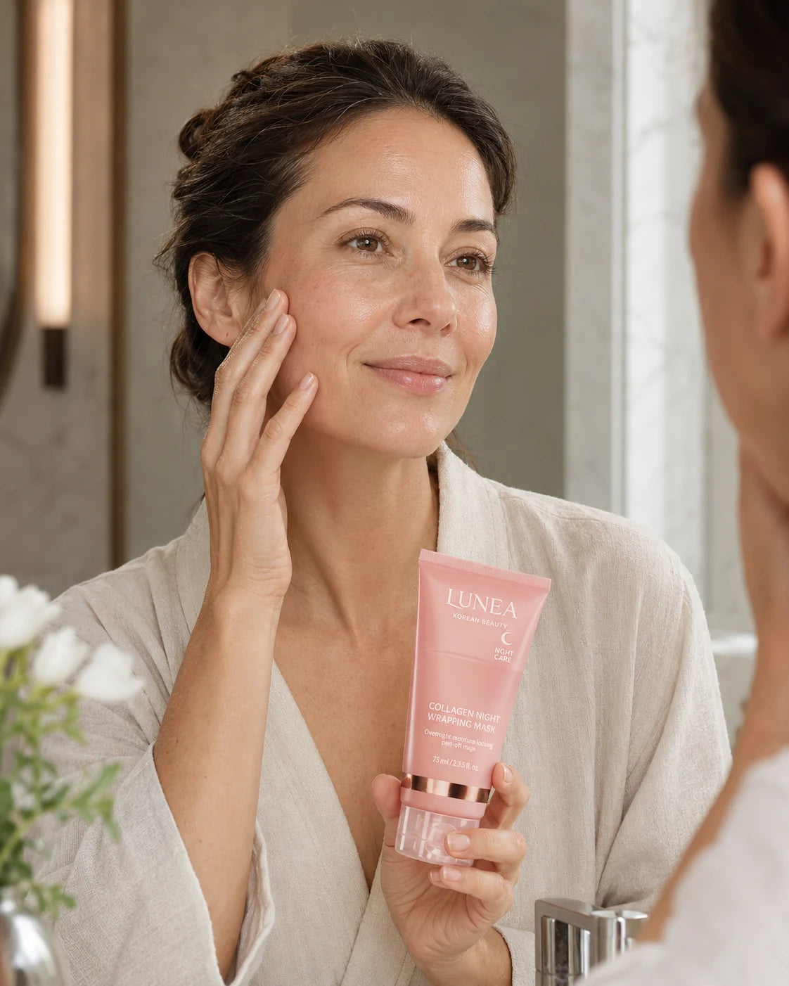 Woman in her late thirties viewing brighter more even-looking skin in consistent natural morning light